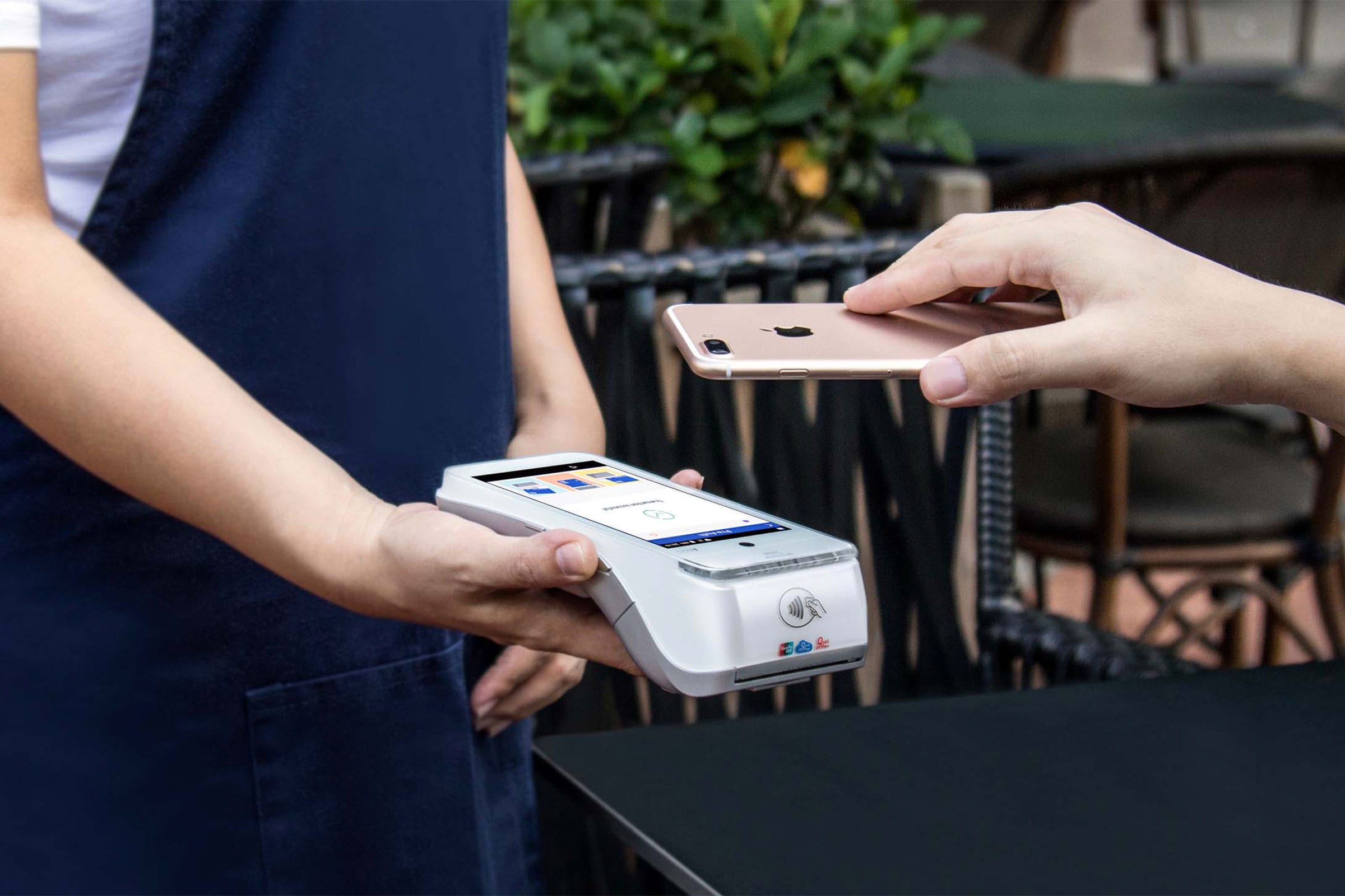 Person paying with their phone on an Android POS terminal  