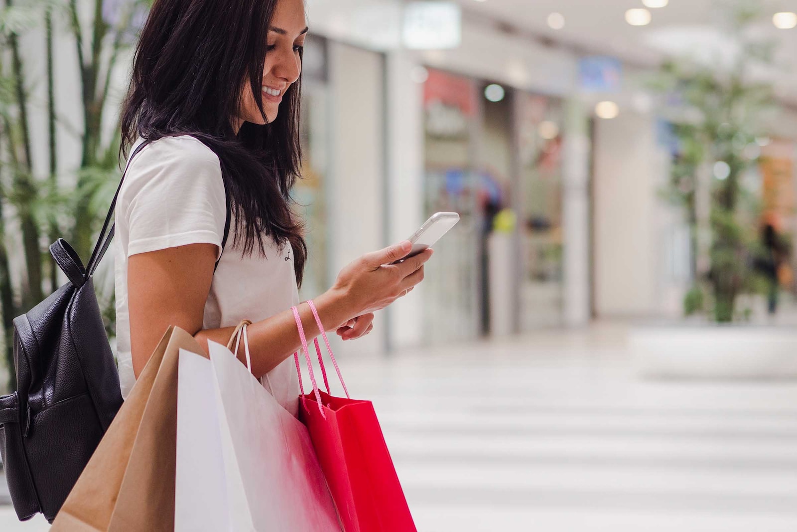 Woman in a shopping center with bags in hand