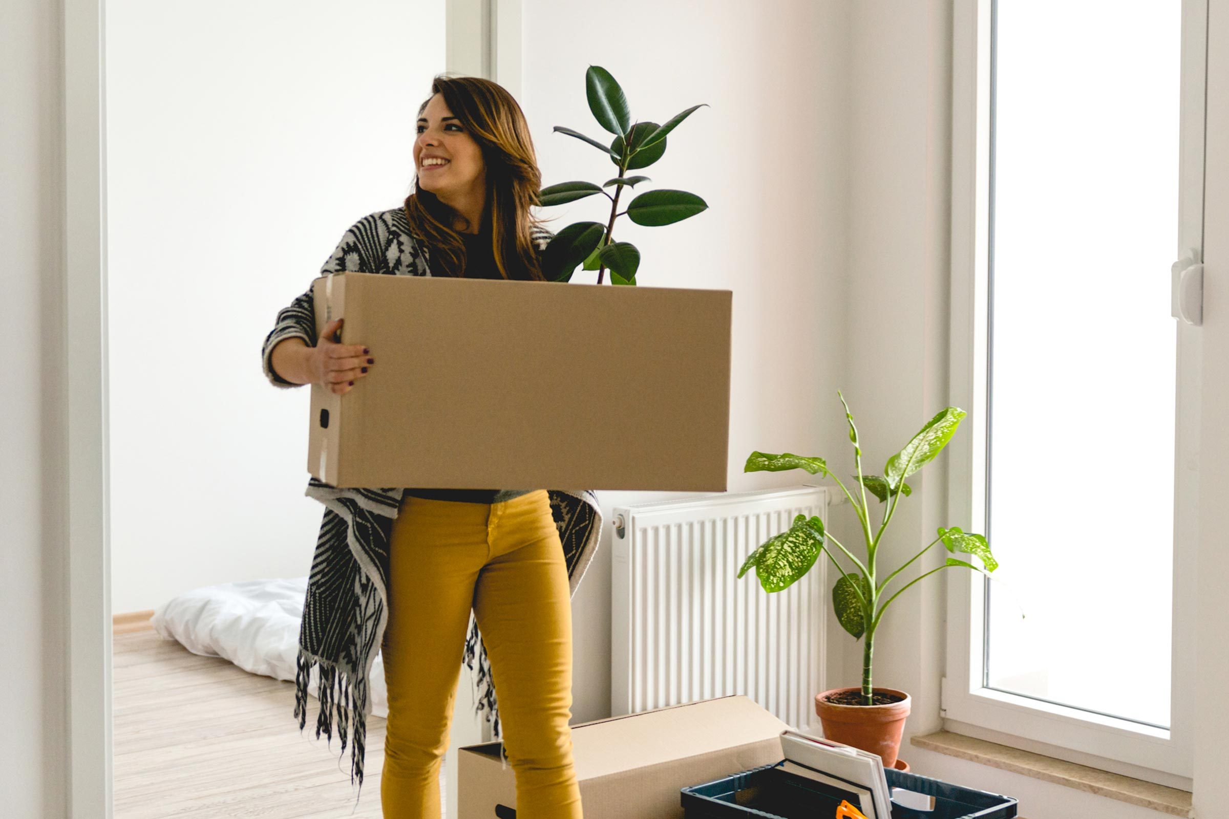 Woman entering her new home with boxes