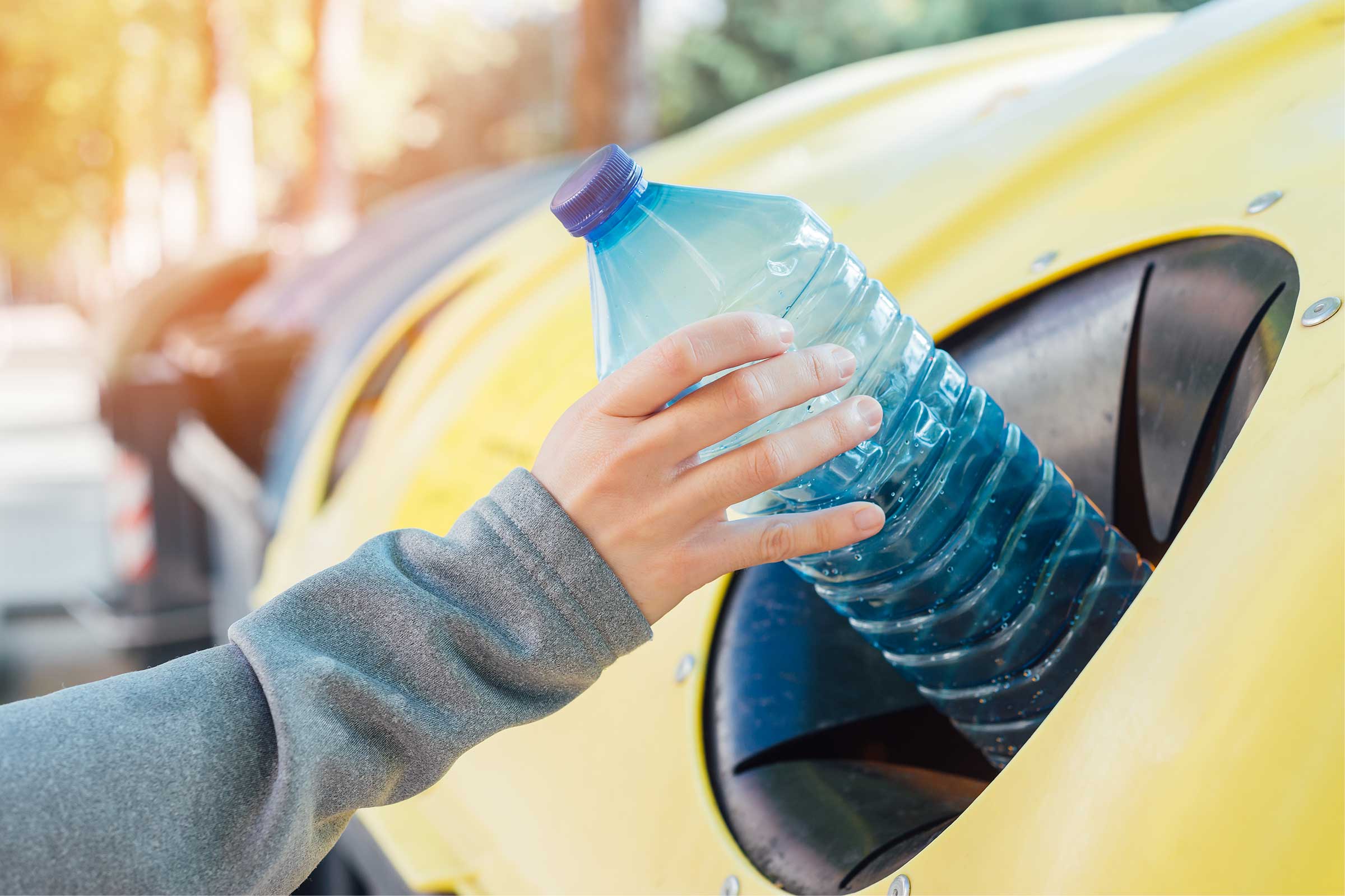 Person recycling a water bottle