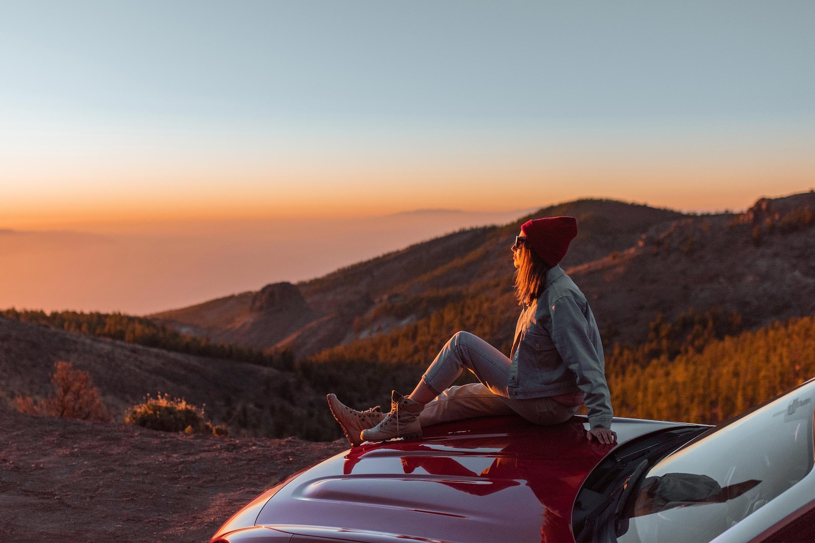 Woman looking at her car at dusk  