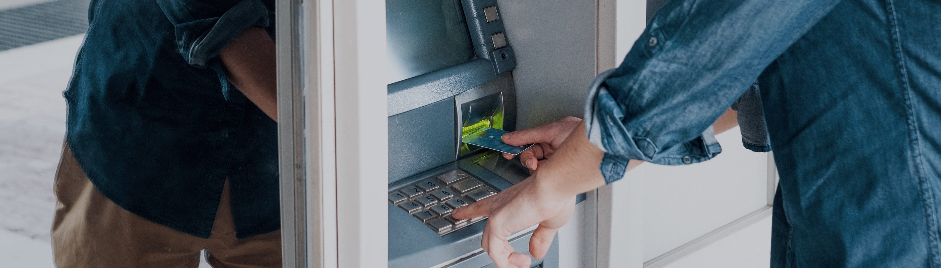 Man banking at an ATM